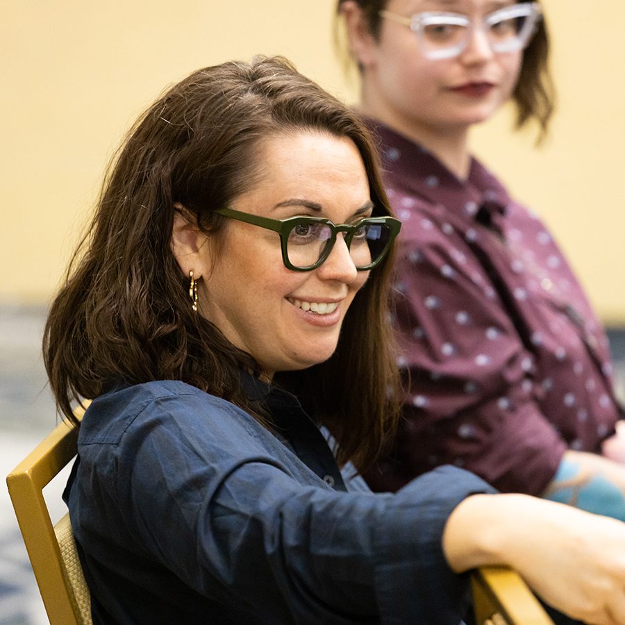 Woman smiling in a group discussion