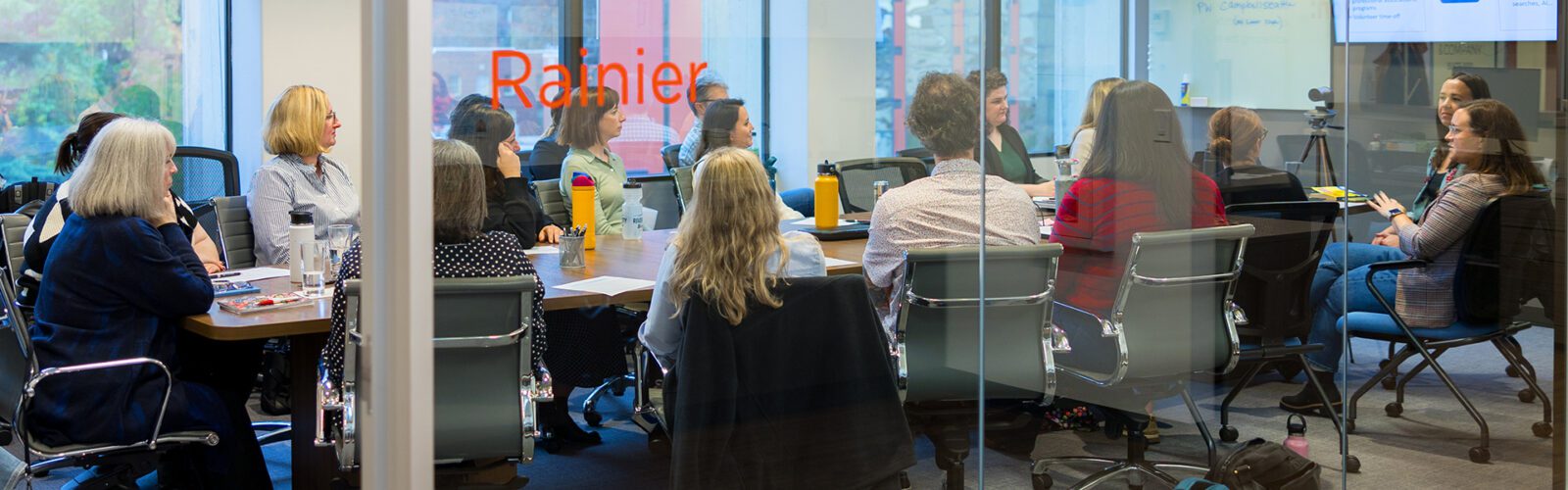 Campbell & Company team members are having a meeting in the conference room.